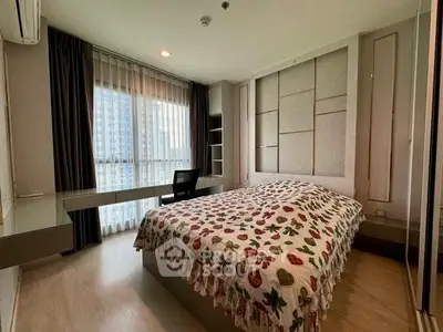 Modern bedroom with large window and stylish decor in a high-rise apartment.