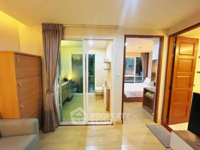 Modern apartment interior with cozy living room and bedroom, featuring wooden flooring and stylish furniture.