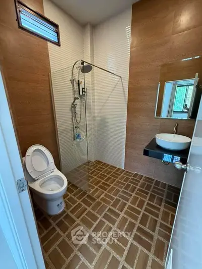 Modern bathroom with glass shower and stylish tile flooring