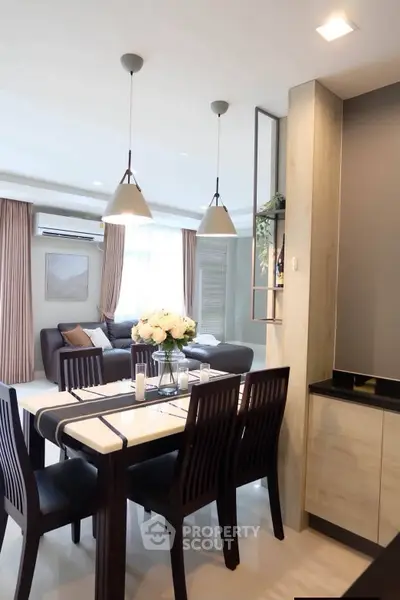 Modern open-plan living and dining area with elegant decor and ample natural light.