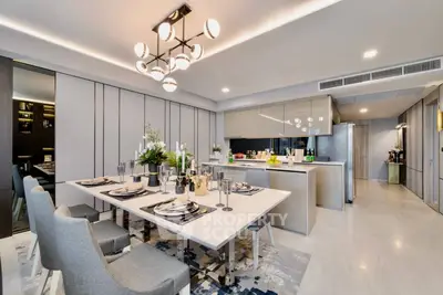 Luxurious open-plan kitchen and dining area with modern decor and elegant lighting