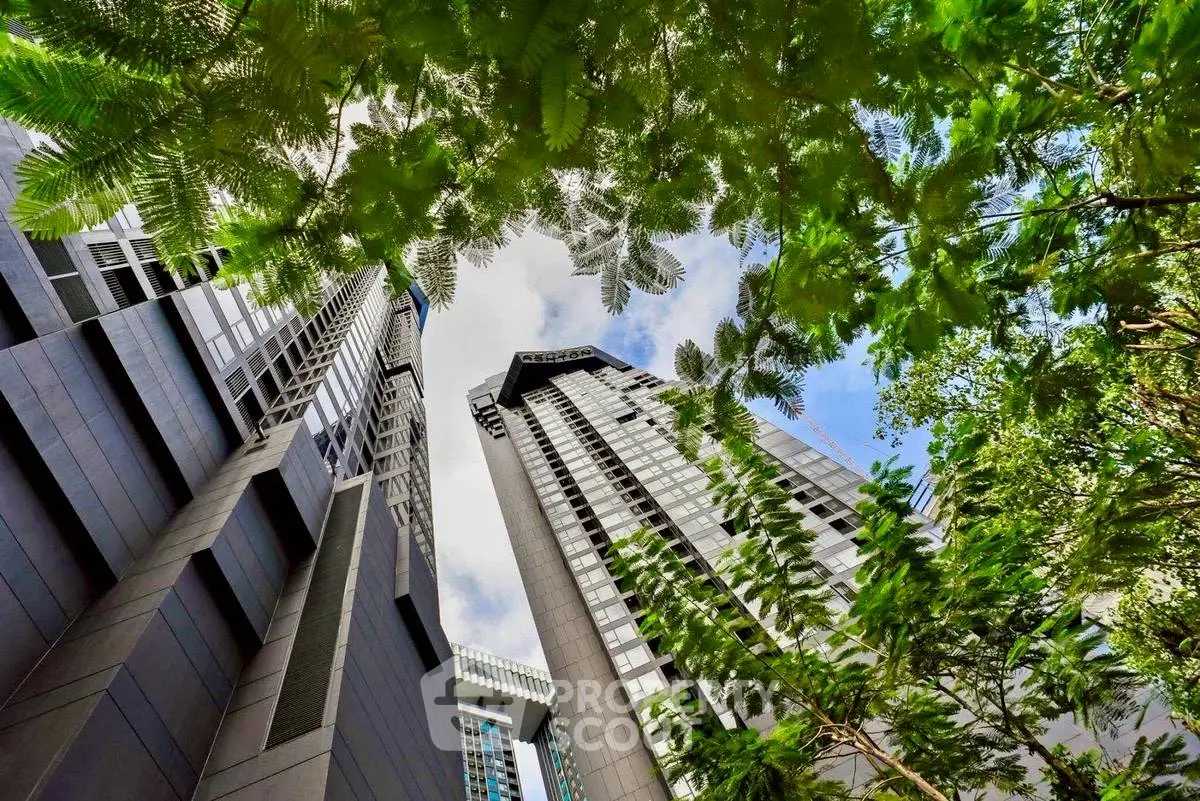 Stunning view of modern high-rise buildings surrounded by lush greenery.
