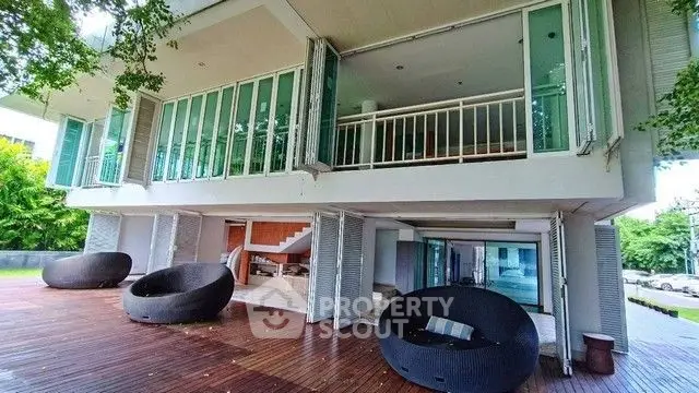 Modern two-story building with spacious outdoor seating area and large windows