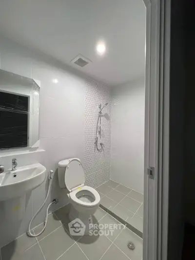 Modern bathroom with sleek fixtures and elegant tile design, perfect for a contemporary home.