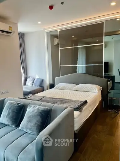 Modern studio apartment with cozy bed and stylish decor