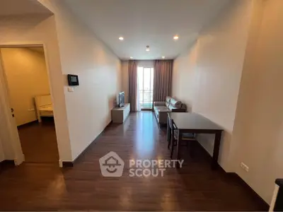 Spacious living room with modern furniture and large window offering natural light.