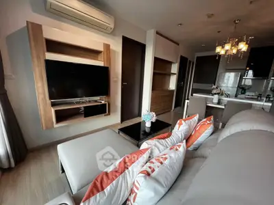 Modern living room with stylish decor and open kitchen layout in a contemporary apartment.