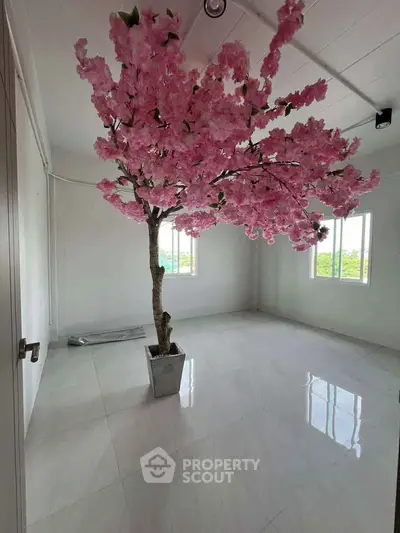 Spacious room with elegant cherry blossom decor and large windows