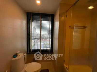 Modern bathroom with city view and glass shower enclosure