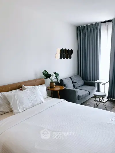 Modern bedroom with cozy seating area and stylish decor