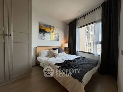 Cozy modern bedroom with large window and stylish decor