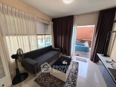 Cozy living room with modern decor and large windows for natural light