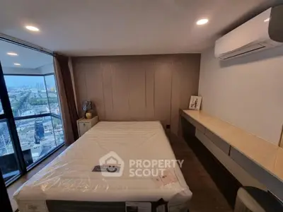 Modern bedroom with city view, featuring a large bed, air conditioning, and sleek design elements.