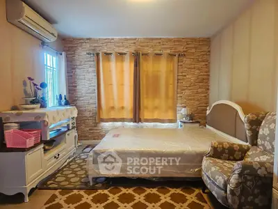 Cozy bedroom with stylish stone accent wall and elegant furniture