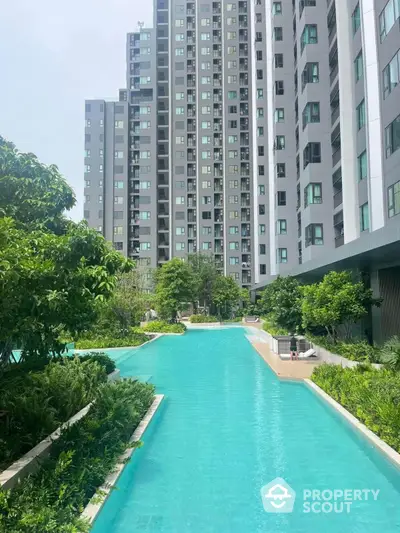 Luxurious condominium with stunning pool and lush greenery, perfect for modern living.