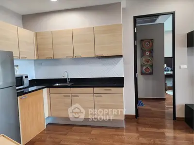 Modern kitchen with sleek wooden cabinets and stylish backsplash
