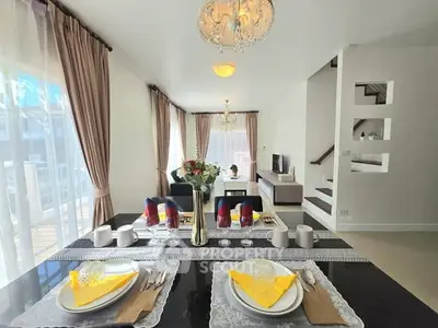Elegant open-plan living and dining area with modern decor and natural light.