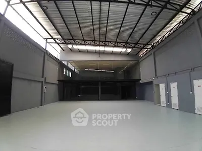 Spacious industrial warehouse with high ceilings and modern design, perfect for storage or business operations.