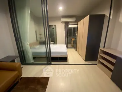 Modern bedroom with glass partition and stylish furniture