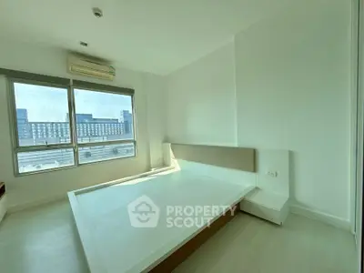 Spacious bedroom with large window and modern design in urban apartment
