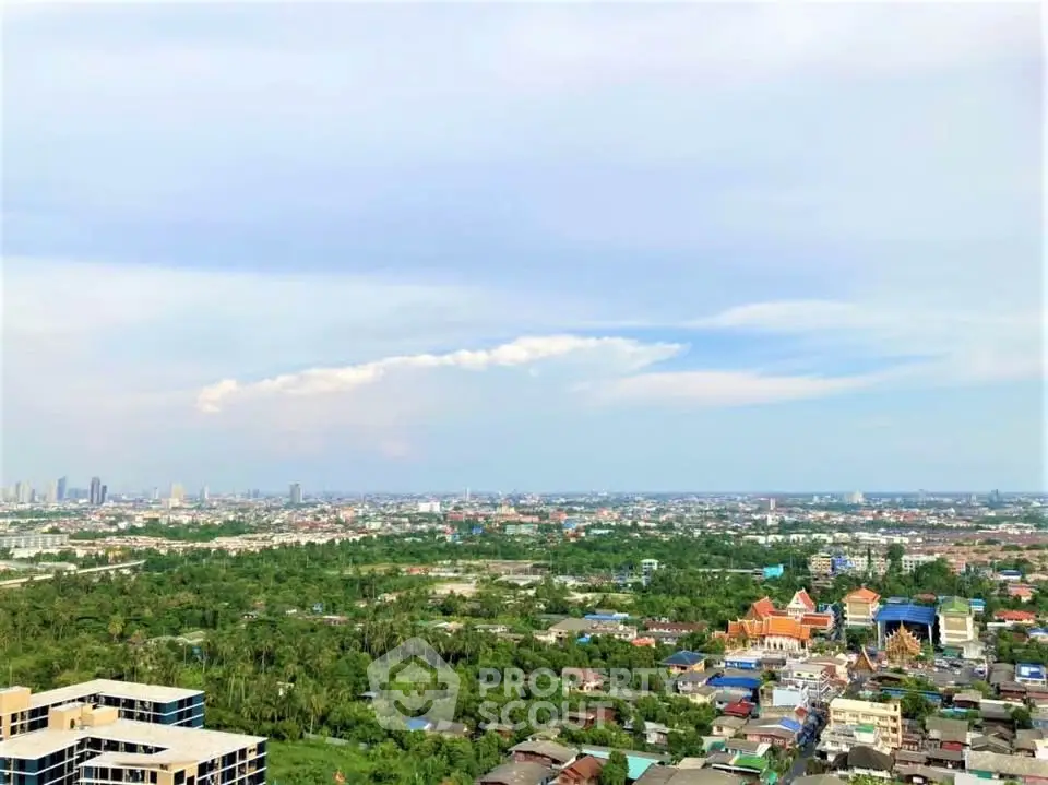 Stunning panoramic cityscape view from high-rise building, showcasing lush greenery and urban skyline.
