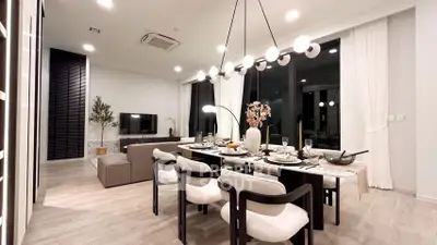 Luxurious modern dining and living area with elegant lighting and stylish decor.