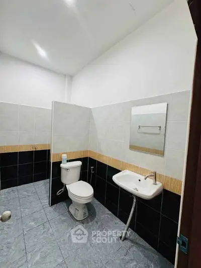 Spacious modern bathroom with sleek tile design and contemporary fixtures.