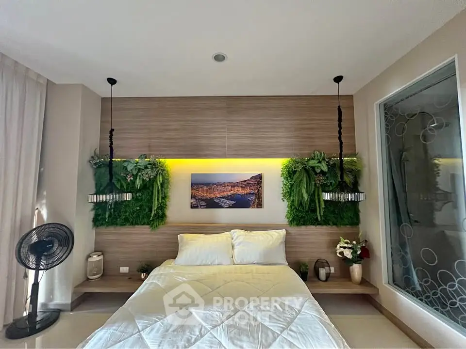 Modern bedroom with stylish decor and greenery accents