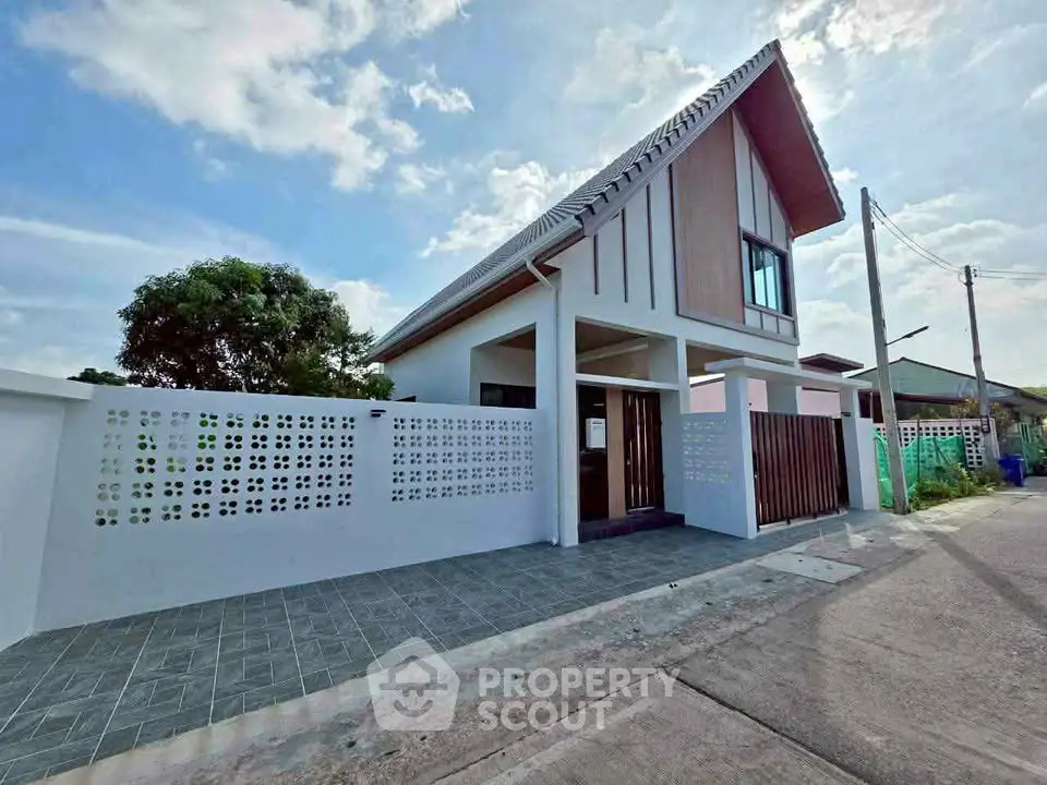 Modern single-story house with stylish facade and spacious driveway in a serene neighborhood.