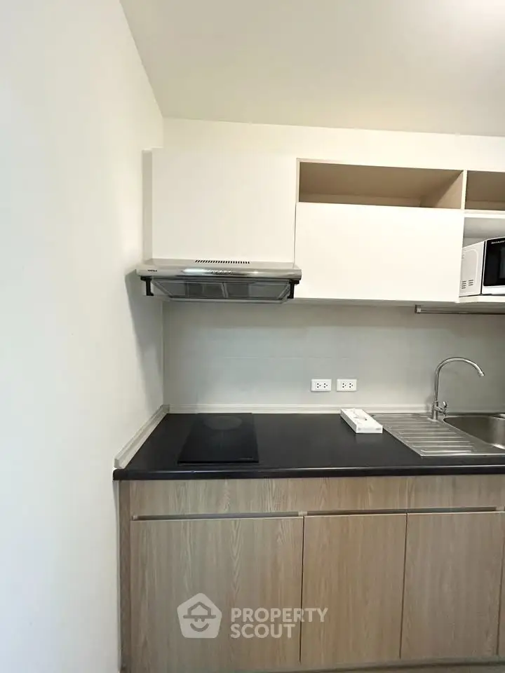 Modern kitchen with sleek cabinetry and built-in appliances in a stylish apartment.