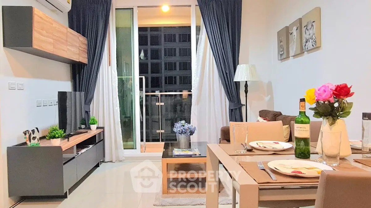 Modern living room with balcony, stylish decor, and elegant dining setup in a cozy apartment.