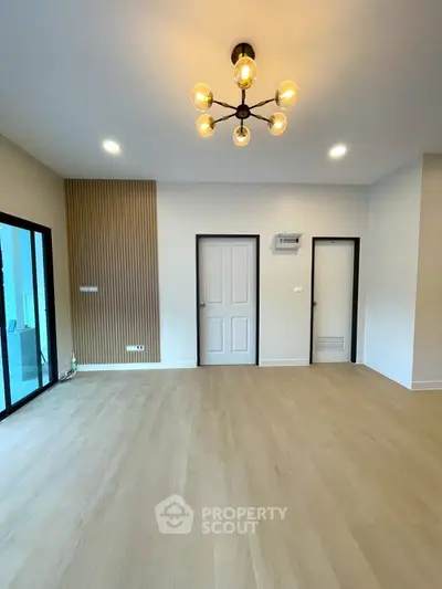 Spacious modern living room with elegant lighting and wooden flooring