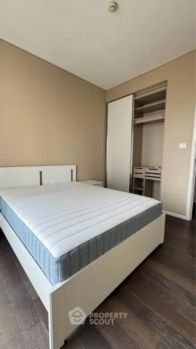 Spacious bedroom with modern design and built-in closet, perfect for comfortable living.