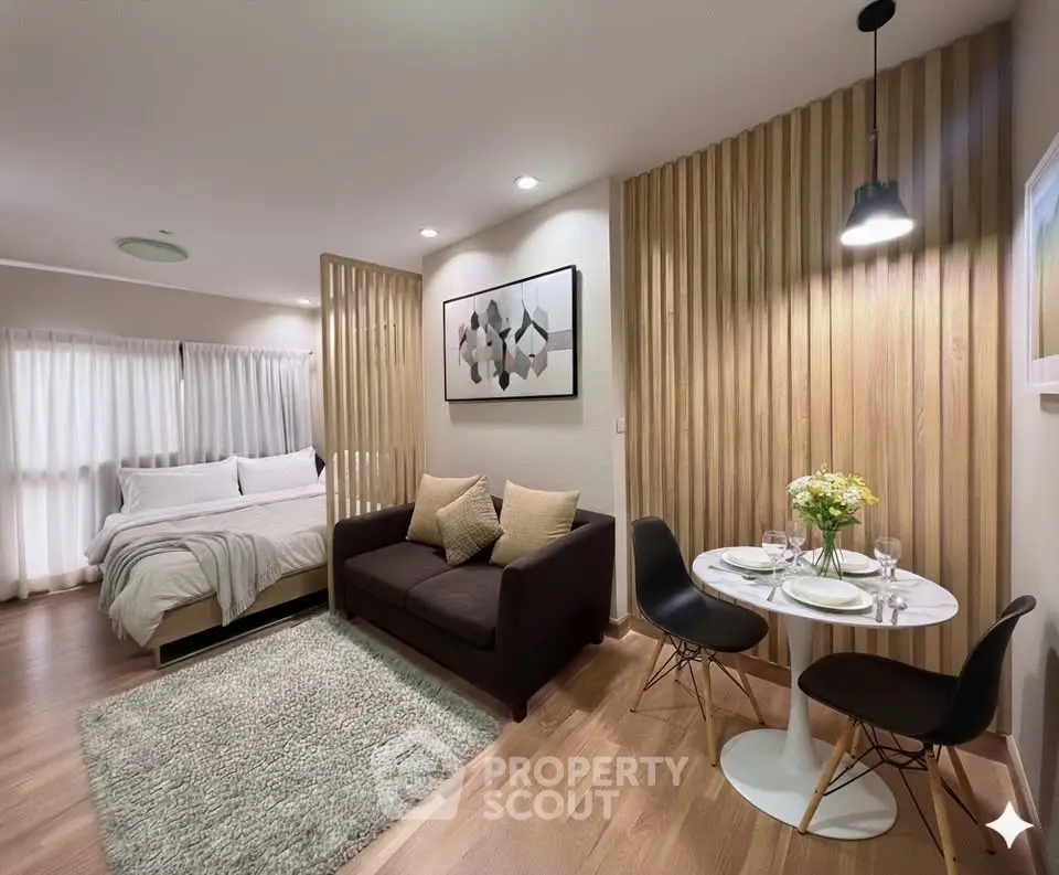 Modern studio apartment with cozy living area and stylish dining space