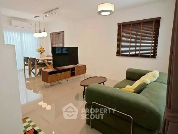 Stylish living room with modern furniture and dining area, perfect for family gatherings.