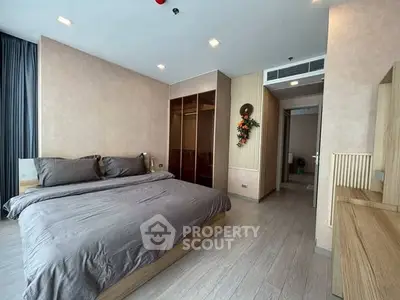 Spacious modern bedroom with elegant decor and ample natural light