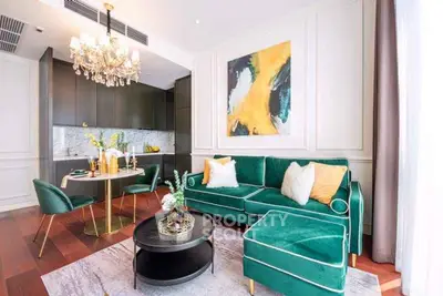 Luxurious living room with elegant green sofa and modern kitchen