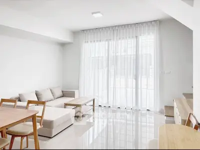 Bright and modern living room with sleek furniture and large windows for natural light.