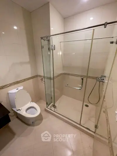 Modern bathroom with glass shower enclosure and sleek fixtures