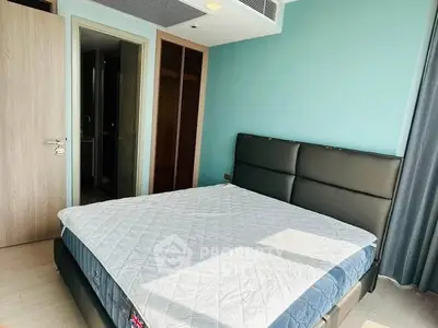 Modern bedroom with stylish bed and natural light in a contemporary apartment.