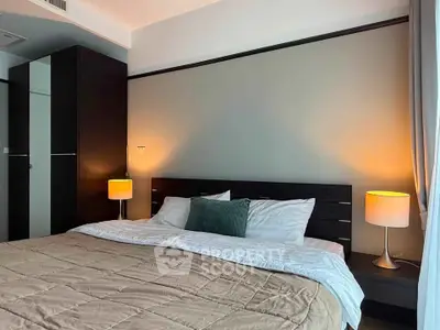 Cozy bedroom with modern decor and ambient lighting, perfect for relaxation.