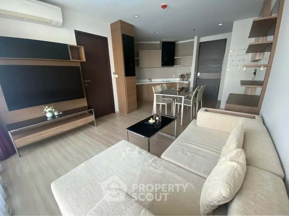 Modern living room with open kitchen and stylish furniture in a cozy apartment.
