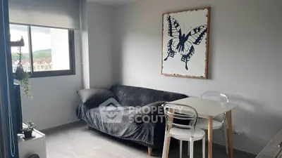 Cozy modern living room with ample natural light, featuring a stylish sofa, minimalist dining set, and an artistic butterfly wall art, perfect for urban living.