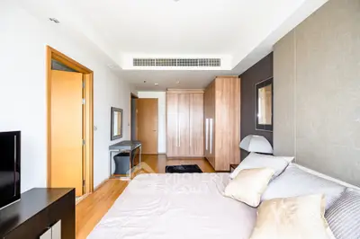 Spacious modern bedroom with wooden accents and stylish decor