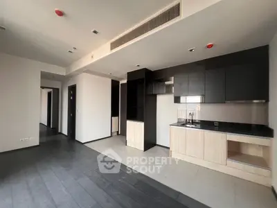 Modern open-plan kitchen with sleek cabinetry and spacious layout in a contemporary apartment.