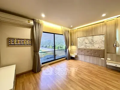 Spacious bedroom with elegant decor and scenic balcony view