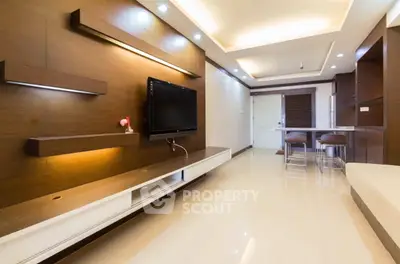 Modern living room with sleek wooden paneling and open kitchen layout