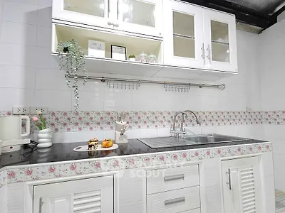 Charming kitchen with floral accents and modern cabinetry