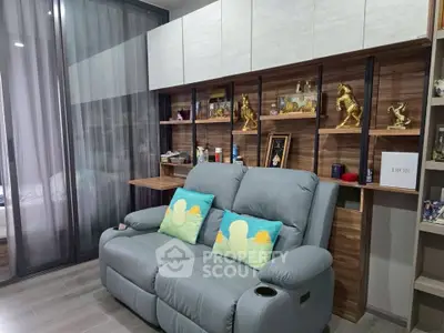 Modern living room with stylish shelving and cozy seating in a contemporary apartment.