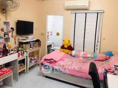 Cozy bedroom with colorful decor and Winnie the Pooh plush, perfect for a child's room.